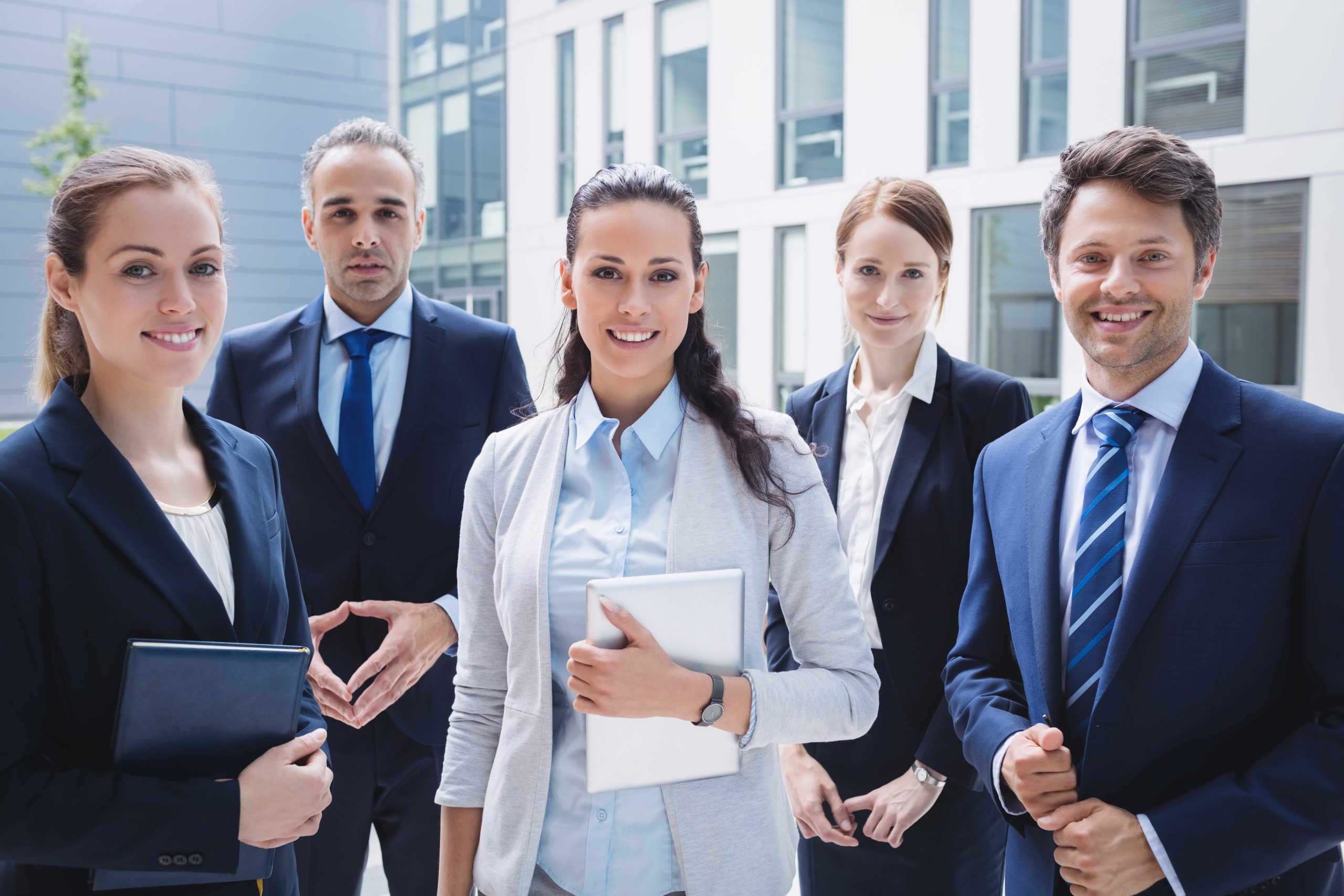 confident-businesspeople-standing-outside-office-building